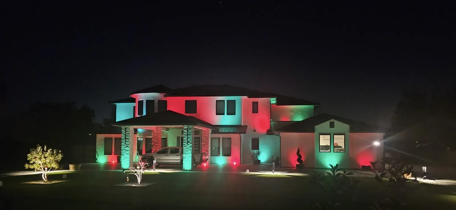 Large custom home lit in red and green