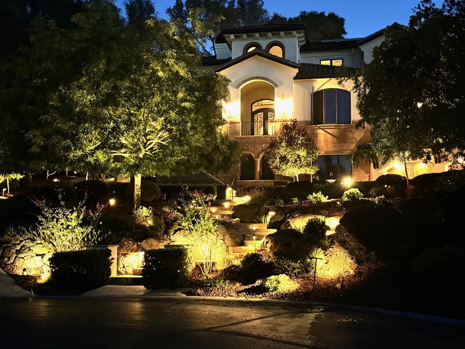 Estate gardens washed in warm light at dusk