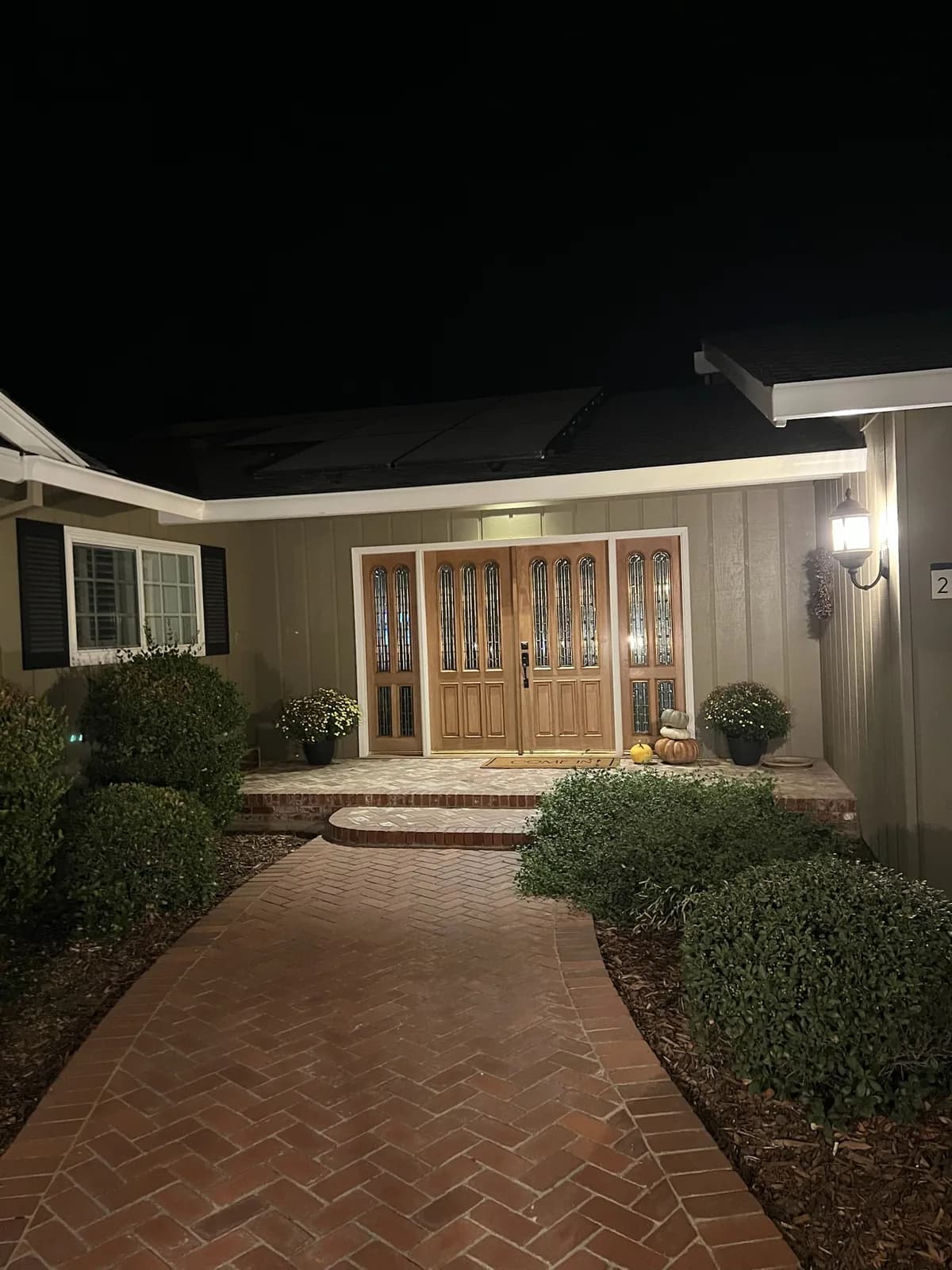 Brick front walk and lit entry
