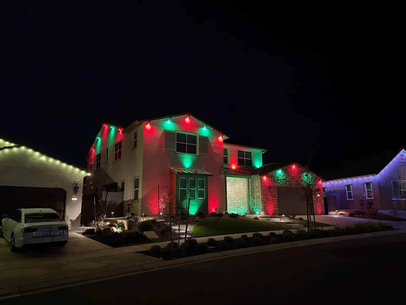 Red and green holiday wash on a two story home
