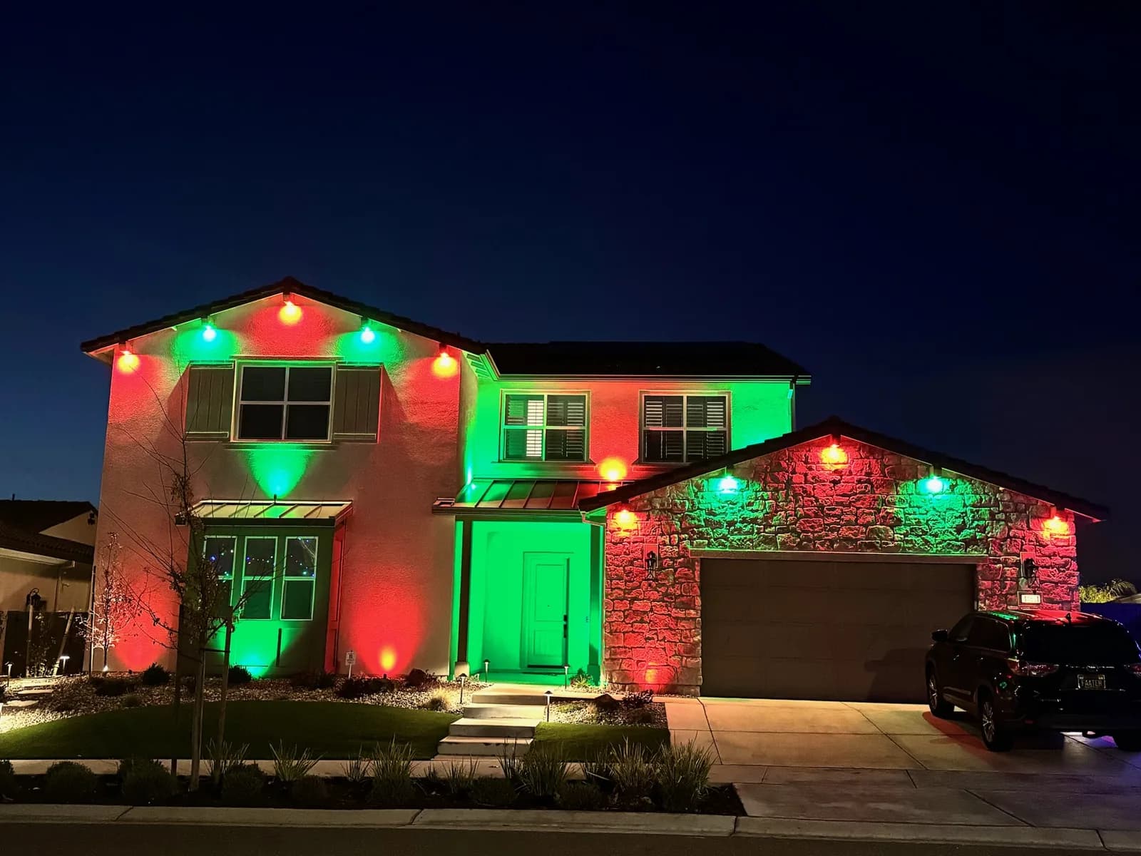 Two story home in red and green for the holidays