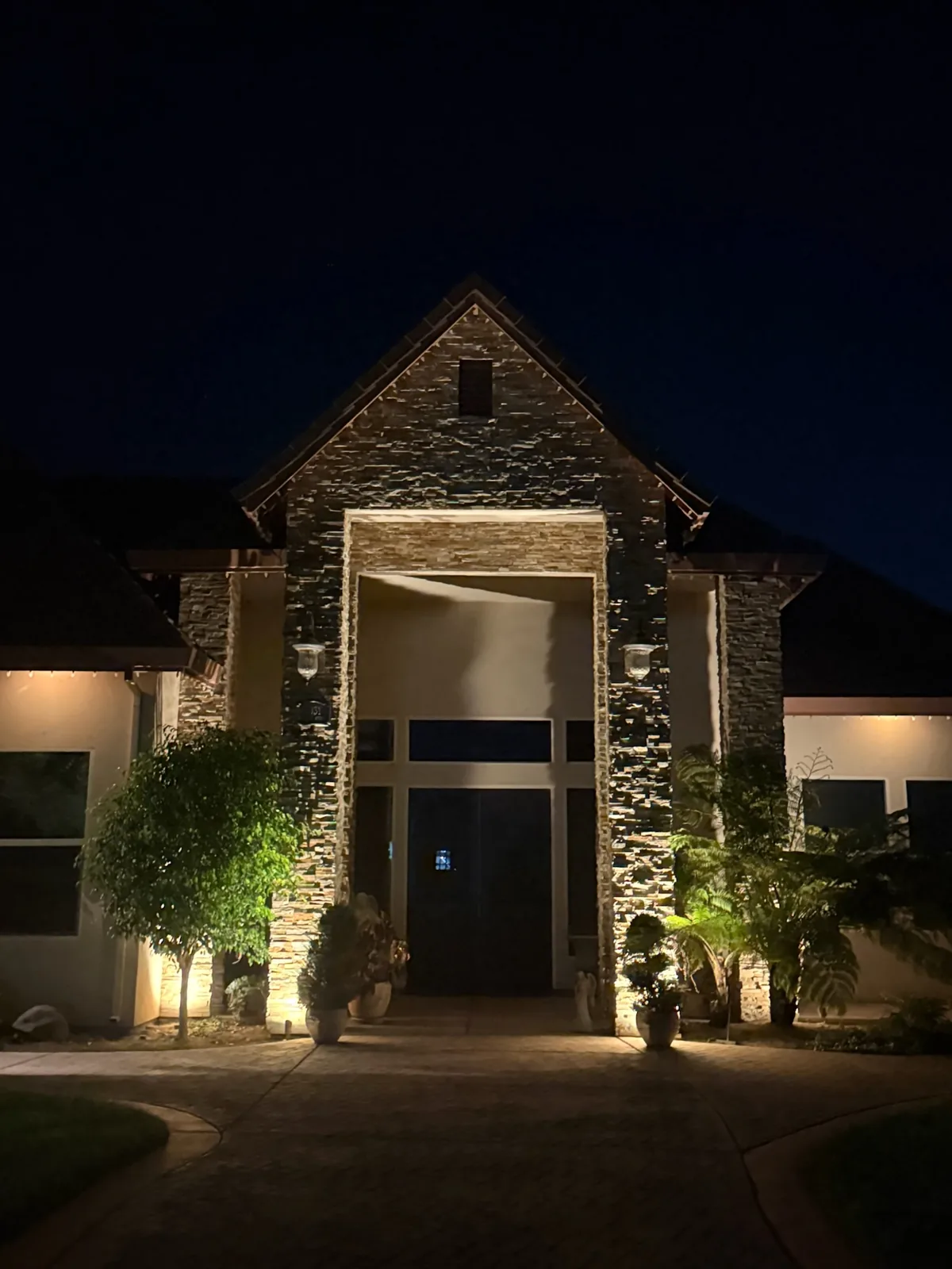 Stone entry tower with warm accent lighting
